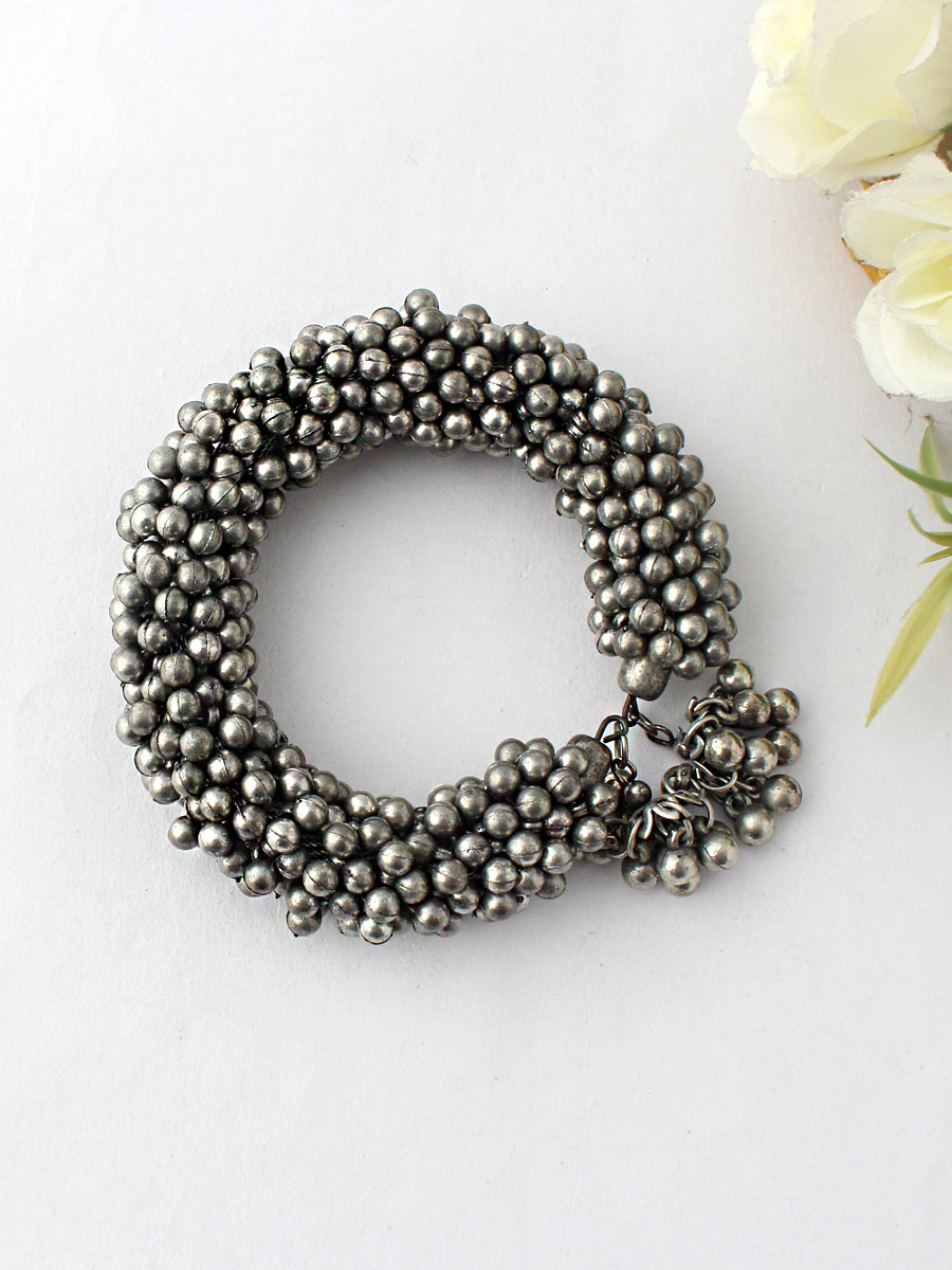 An oxidized silver-tone boho jhumki bangle bracelet with adjustable size and high-grade alloy metal base,